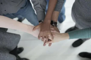 People holding hands together as a community