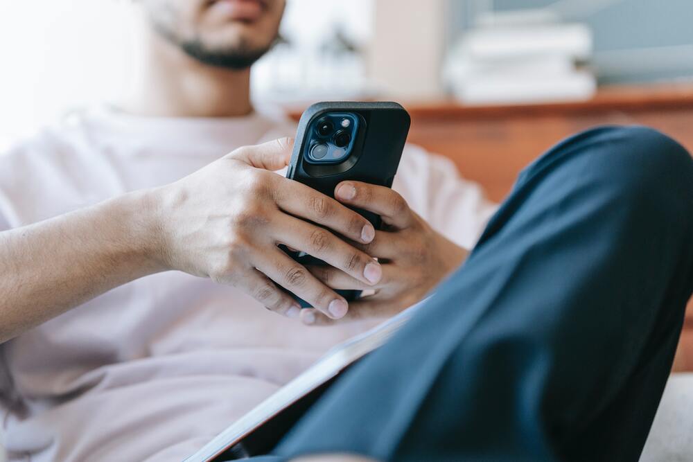 A man using the phone browsing social media