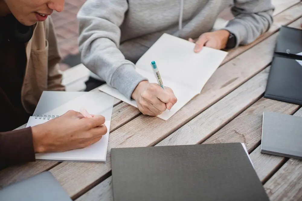 two people writing and studying