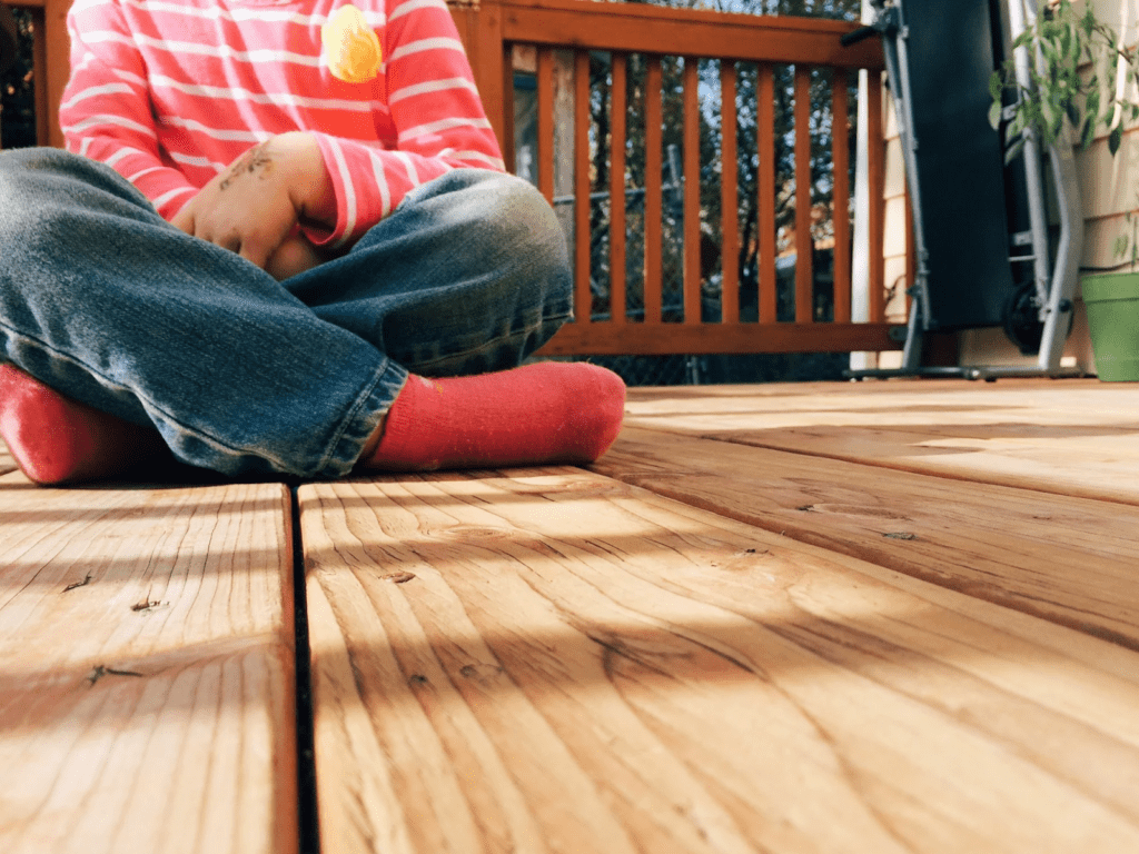 How Sustainable Businesses Provide Eco-Friendly Wood Solutions 2 a kid sitting on a wooden flower